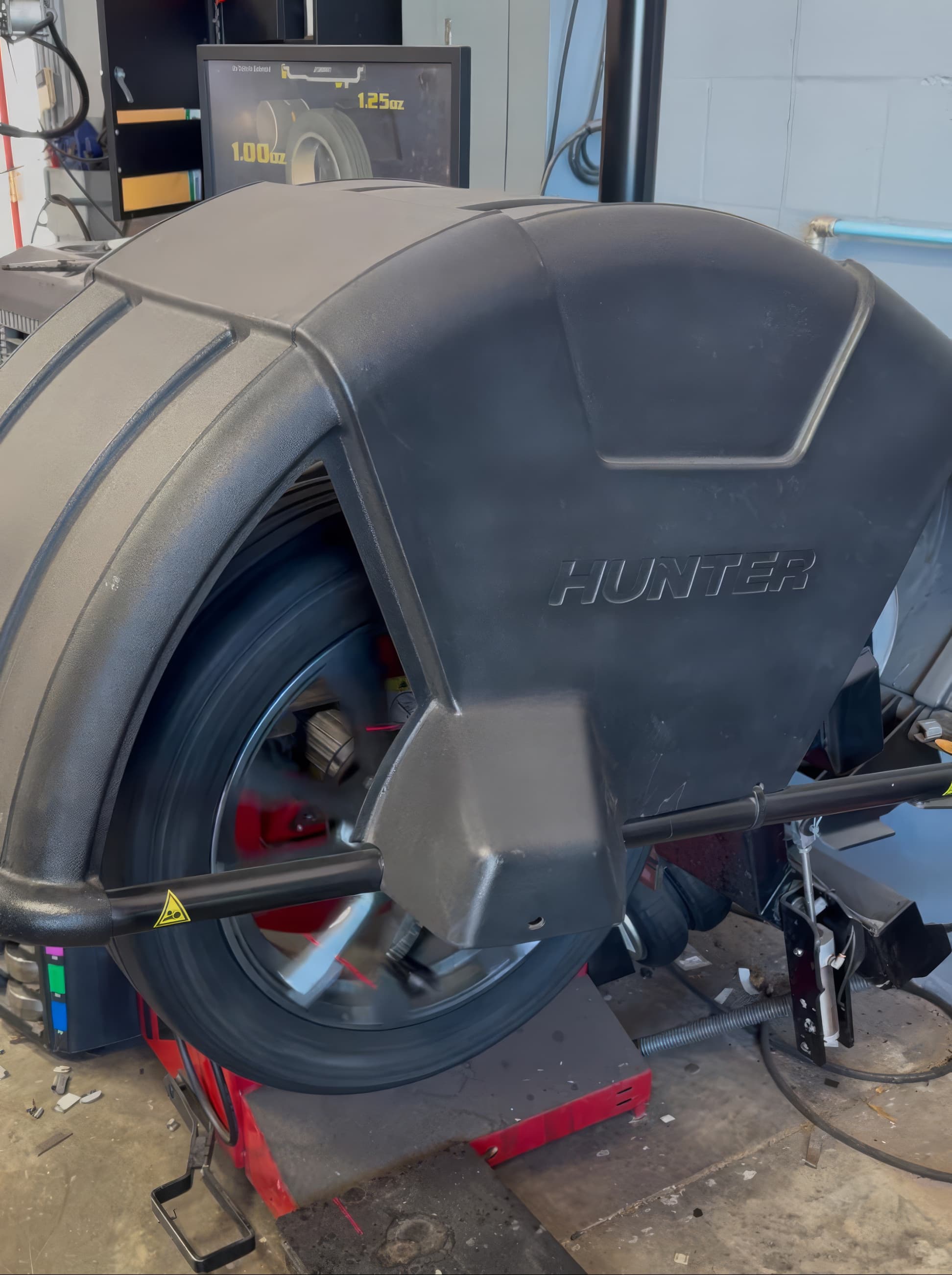 Wheel and tire mounted on a Hunter road force balancer at Johnny's Automotive